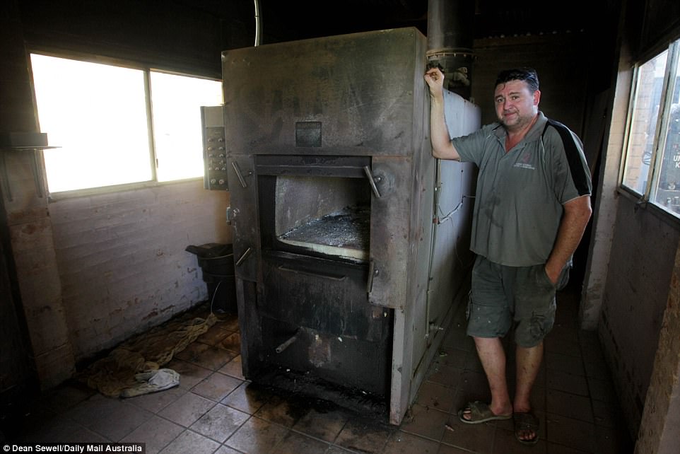 Shane McGraw pictured next to his diesel-powered cremator which once heated to 800 degrees celsius can reduce an average size pet to ash in about two-and-a-half hours
