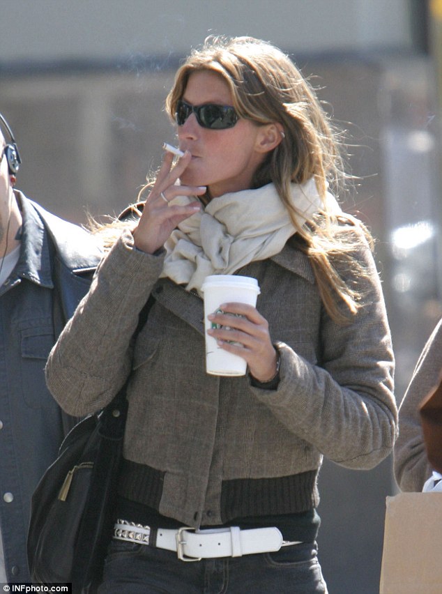 Bad habits: Gisele Bundchen used to smoke a pack of cigarettes a day and drink three frapuccinos - as well as a bottle of wine a day - to deal with stress, she has said; seen in 2004